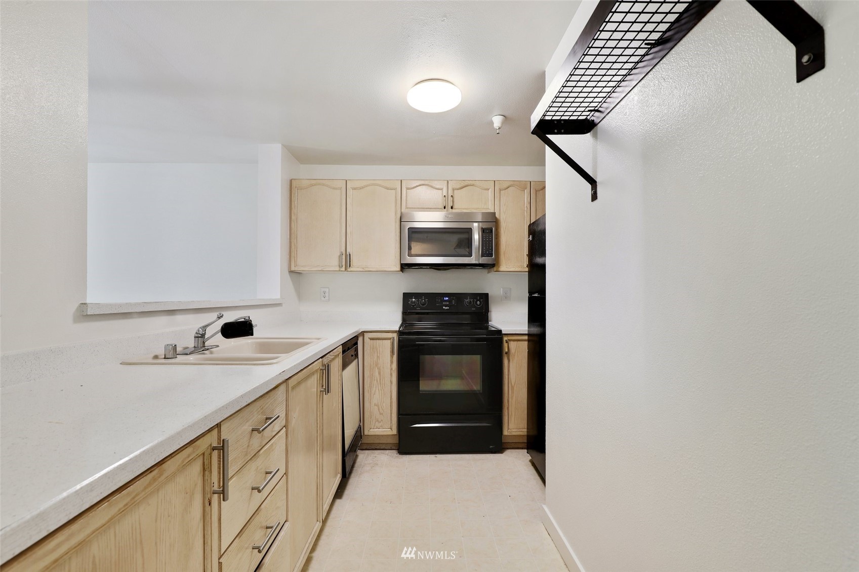 949 Aberdeen Avenue Northeast, Unit B104 Renton, WA 98056 - Photo 8 of 20 a kitchen with stainless steel appliances a sink stove and refrigerator