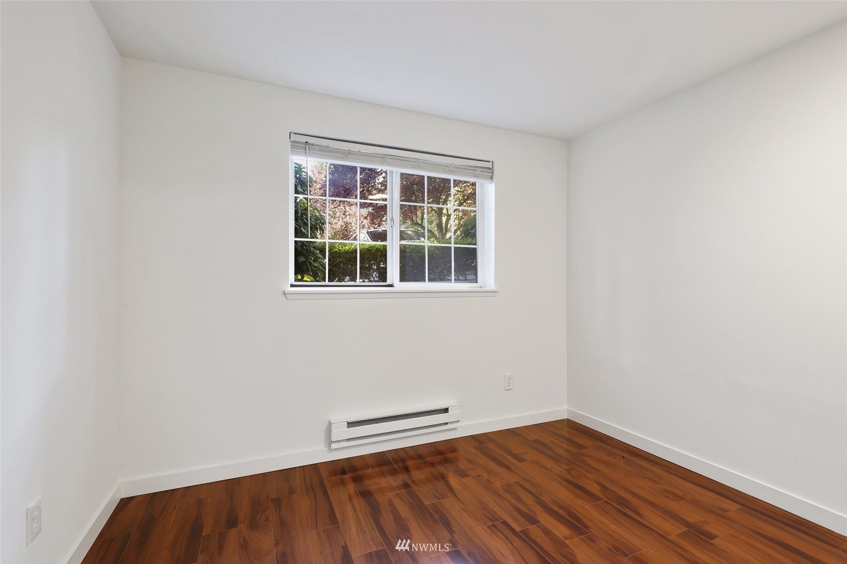 949 Aberdeen Avenue Northeast, Unit B104 Renton, WA 98056 - Photo 10 of 20 a view of an empty room with wooden floor and a window