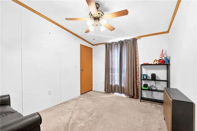 a view of livingroom with furniture and ceiling fan