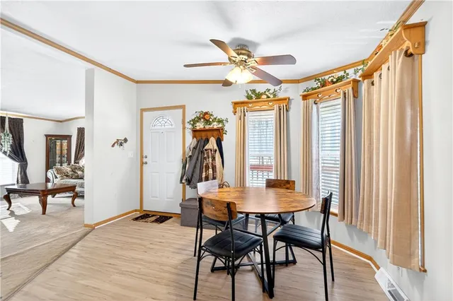 a view of a dining room with furniture and a window