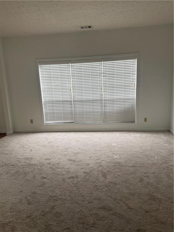 682 Bridge Way Lithonia, GA 30058 - Photo 5 of 25 a view of an empty room with windows