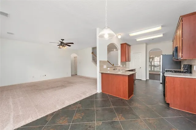 a kitchen with a stove sink and cabinets