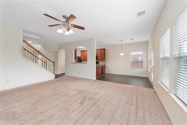 a spacious bathroom with a granite countertop sink a mirror and shower