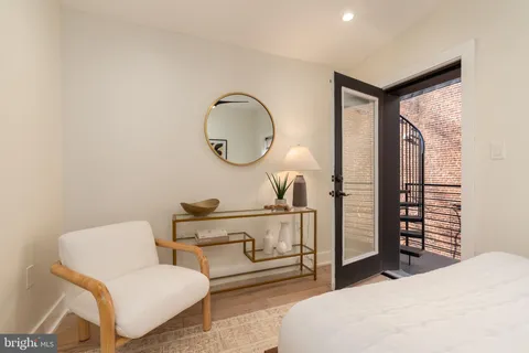 a living room with furniture a mirror and a window