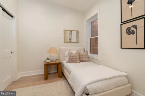 a bedroom with a bed and a table