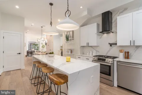 a kitchen with a stove a sink and a refrigerator