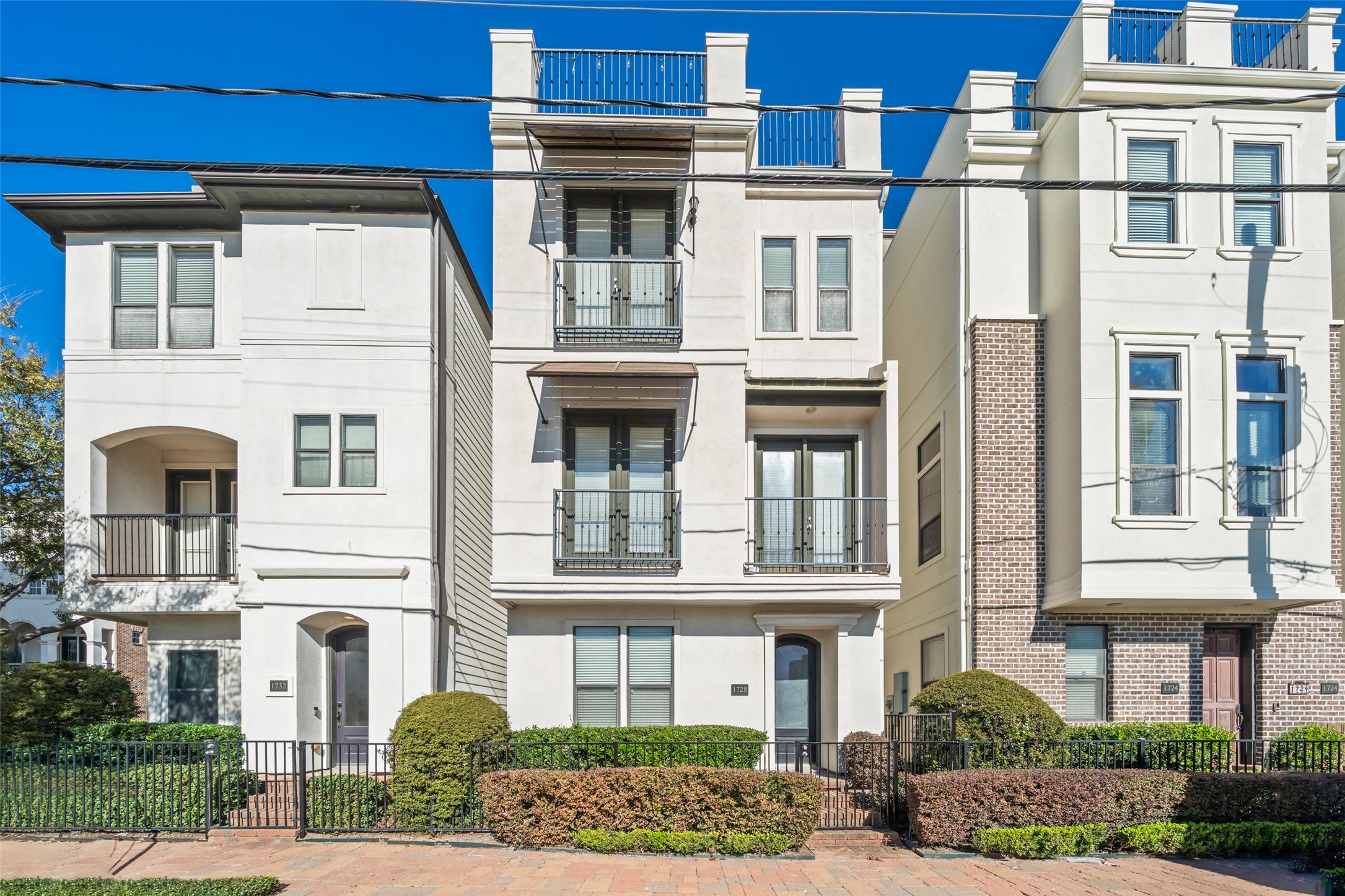 a front view of a residential apartment building with a yard