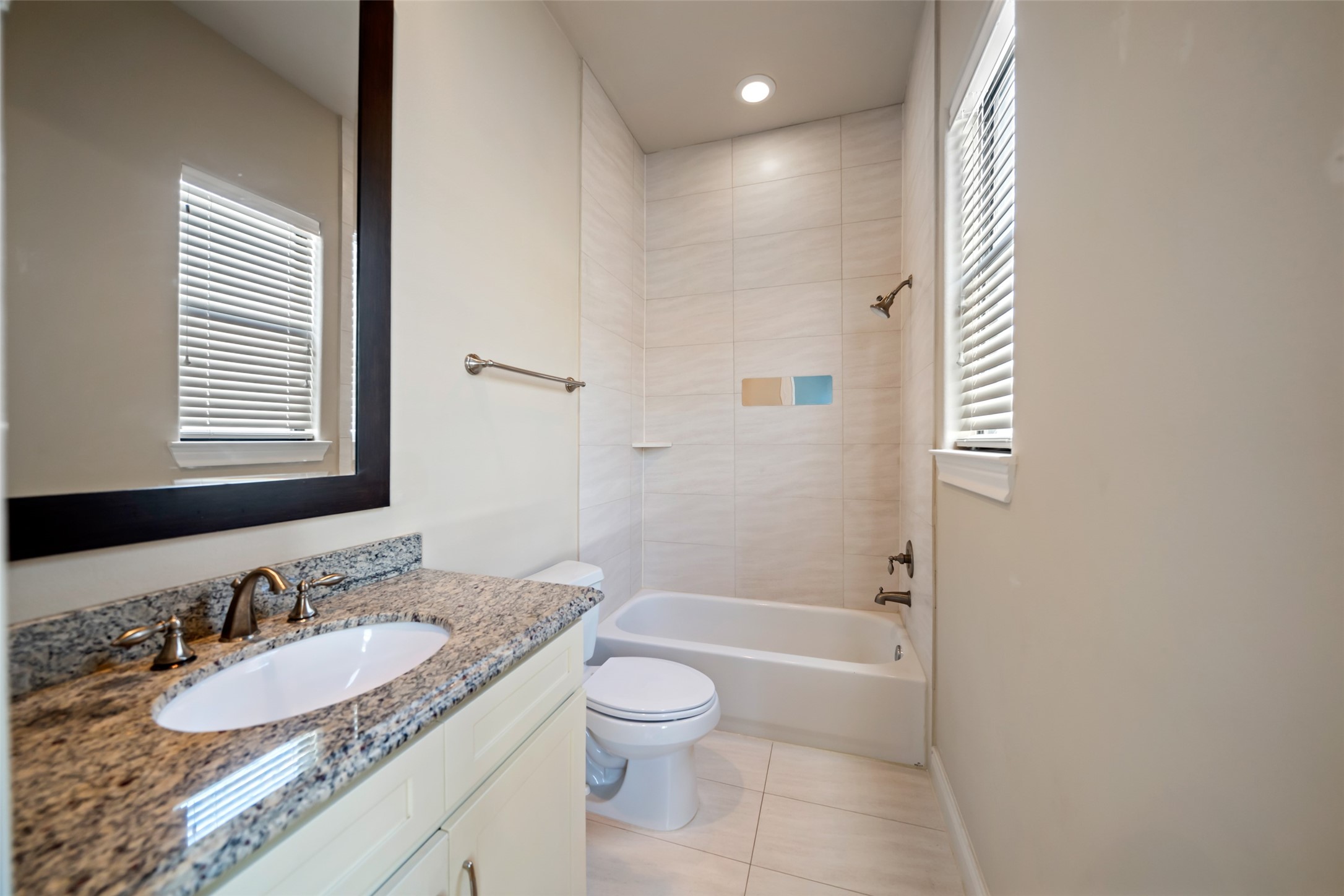 1728 Dart Street Houston, TX 77007 - Photo 23 of 37 a bathroom with a granite countertop sink toilet a mirror and shower