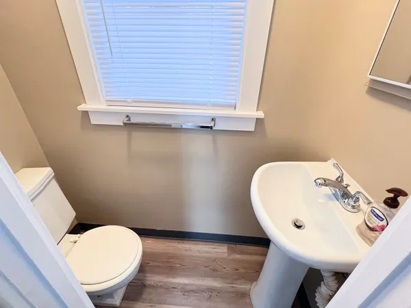 a bathroom with a sink a toilet and a mirror