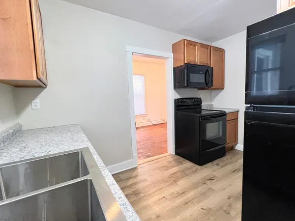 a kitchen with a refrigerator stove and microwave