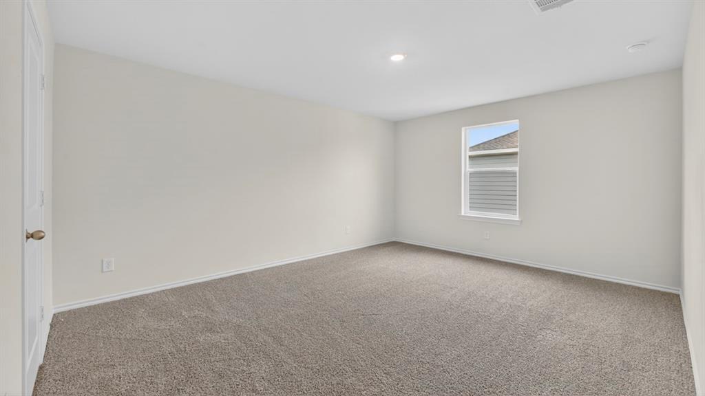 3534 Spring Time Street Forney, TX 75126 - Photo 12 of 24 Spacious room featuring neutral carpeting, light-toned walls, and a single window with exterior siding visible
