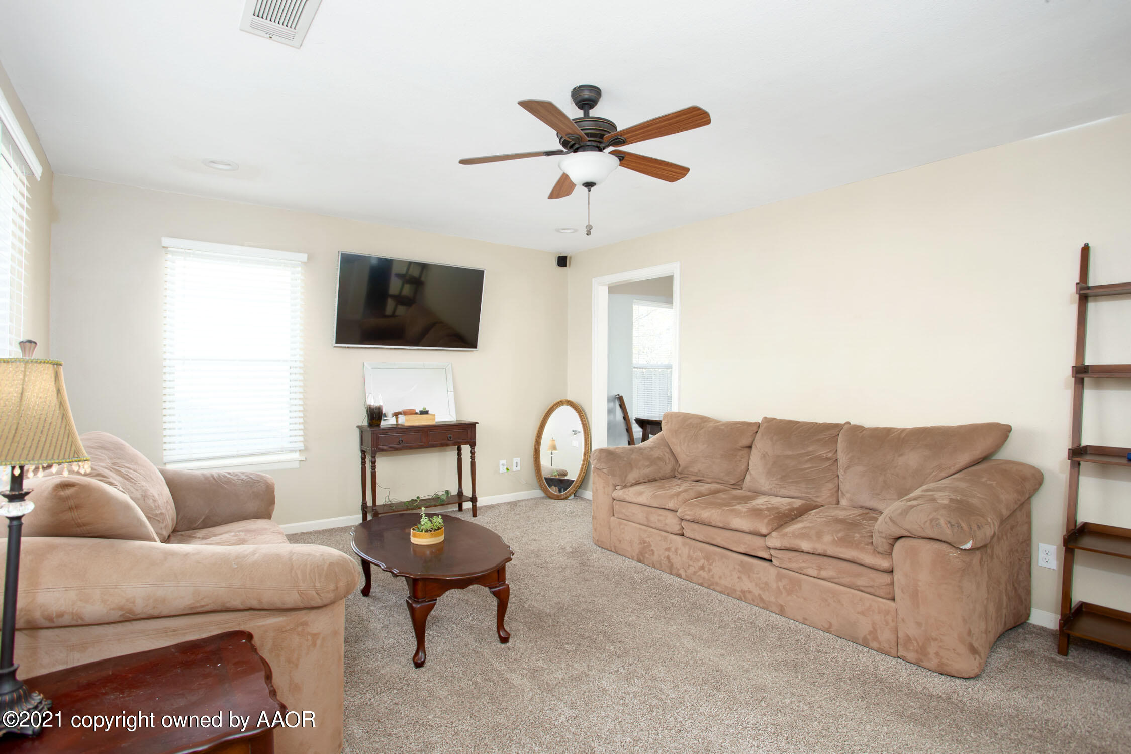 3807 South Jackson Street Amarillo, TX 79110 - Photo 2 of 17 a living room with furniture a flat screen tv and a window