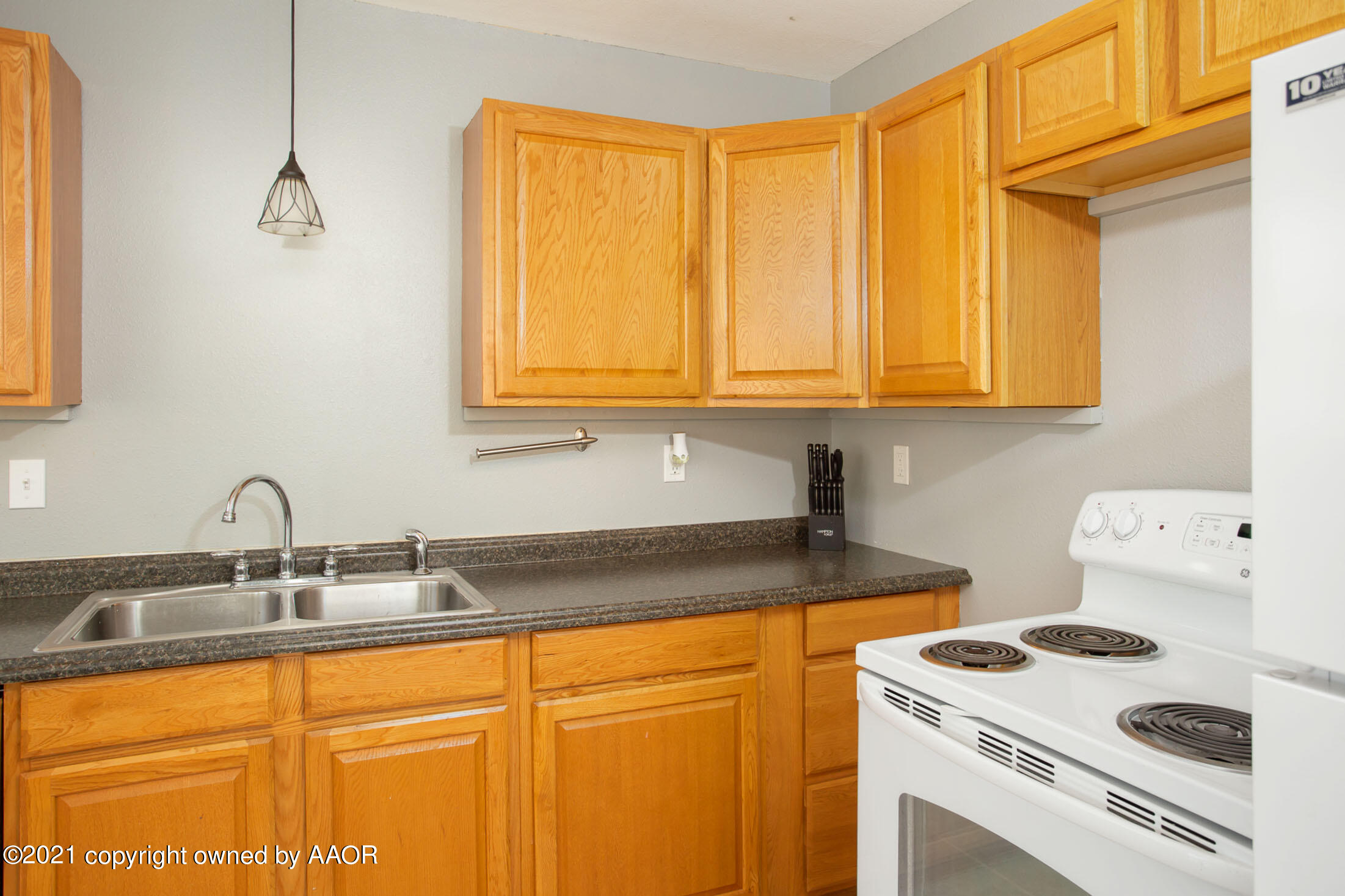 3807 South Jackson Street Amarillo, TX 79110 - Photo 7 of 17 a kitchen with sink cabinets and a table