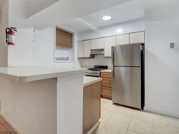 a kitchen with stainless steel appliances a refrigerator and a stove