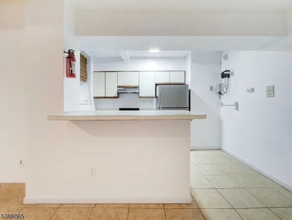 a kitchen with kitchen island a sink and a refrigerator