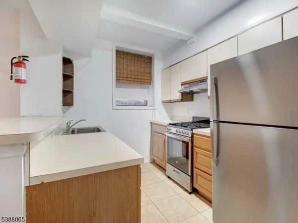 a kitchen with stainless steel appliances a refrigerator stove and sink