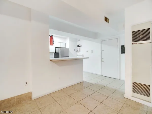 a kitchen with cabinets and wooden floor