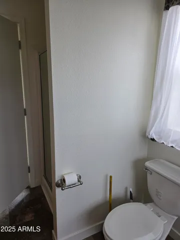 a white toilet sitting next to a shower