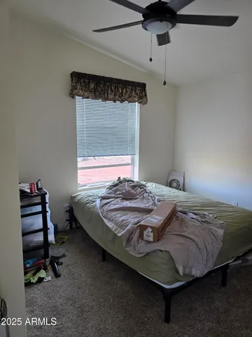 a bedroom with a bed and a window