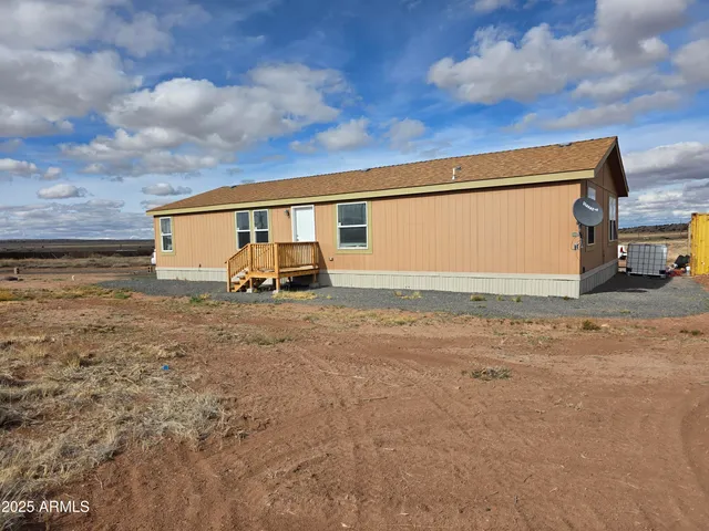 a view of a house with backyard and ocean view