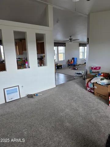 a view of a livingroom with furniture and a window