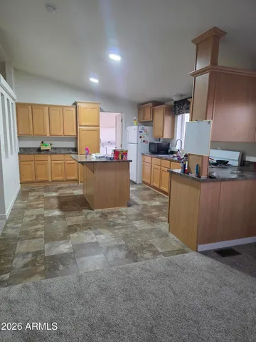 a kitchen with stainless steel appliances a refrigerator and cabinets