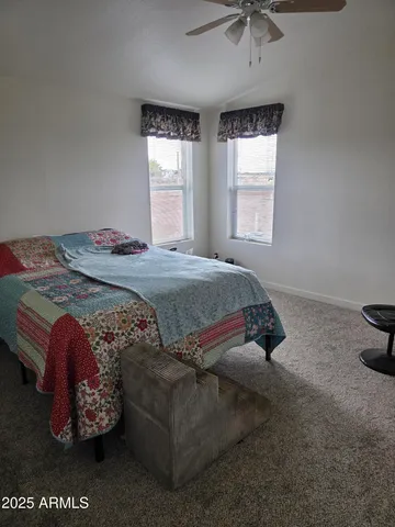 a bed sitting in a bedroom next to a window