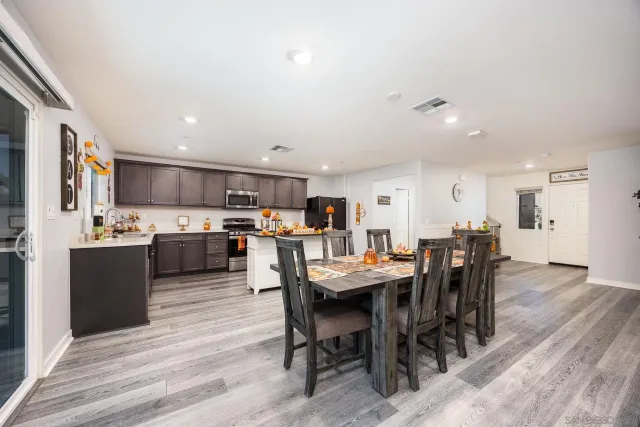 a view of kitchen with cabinets table and chairs