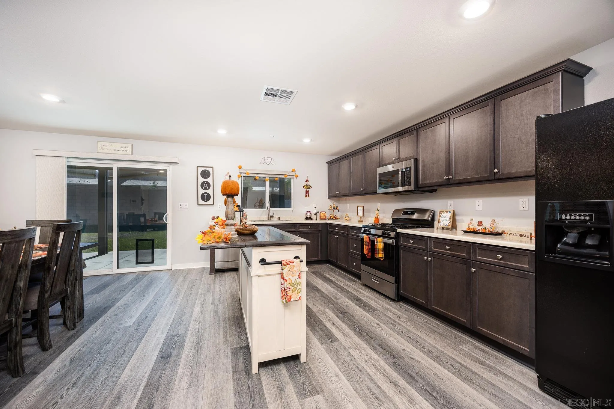 32089 Bunkhouse Road Winchester, CA 92596 - Photo 14 of 26 a large kitchen with stainless steel appliances and wooden cabinets