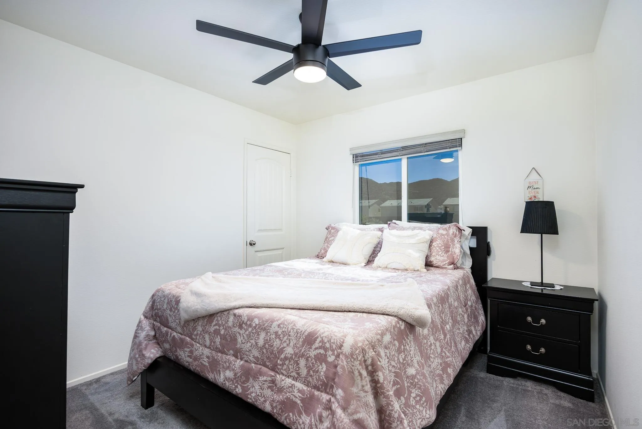 32089 Bunkhouse Road Winchester, CA 92596 - Photo 18 of 26 a bedroom with a bed and a flat tv screen on the dresser