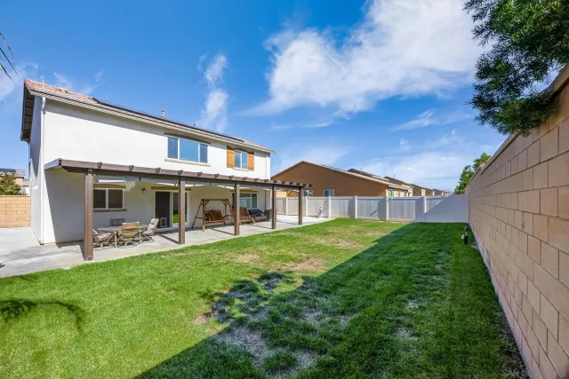 a front view of a house with a yard table and chairs