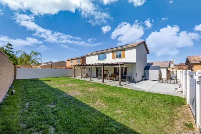 a view of a house with backyard porch and sitting area