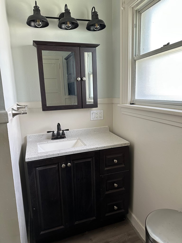 324 16th Street Franklin, PA 16323 - Photo 17 of 24 a bathroom with a granite countertop sink and a toilet