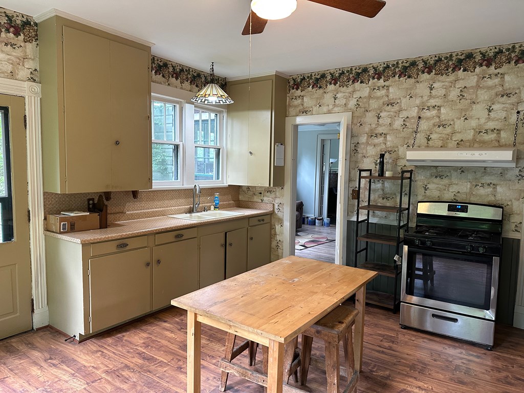 324 16th Street Franklin, PA 16323 - Photo 8 of 24 a kitchen with a sink and wooden cabinets