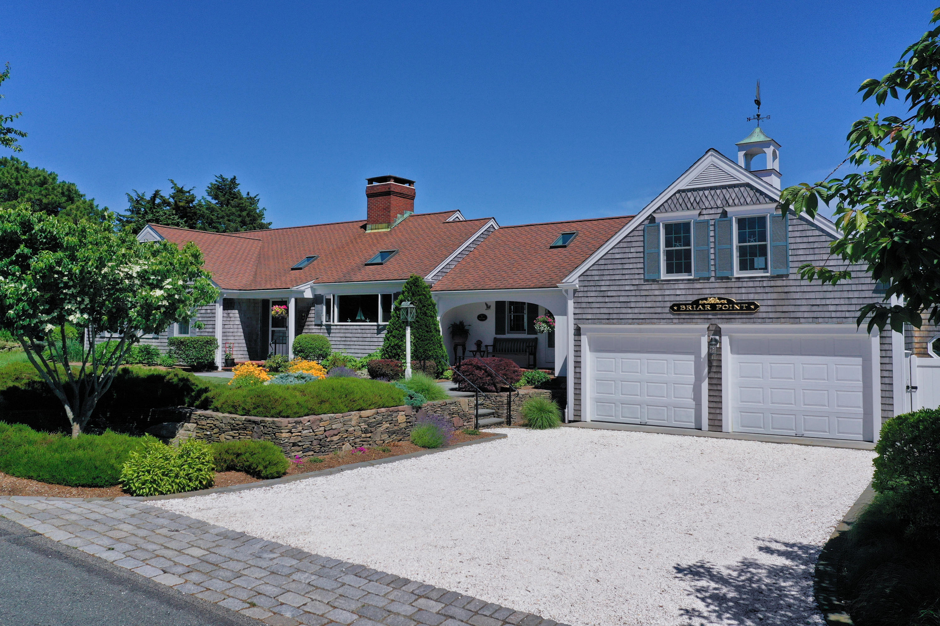71 Briar Spring Road Orleans, MA 02653 - Photo 21 of 45 a front view of a house with a yard and garage