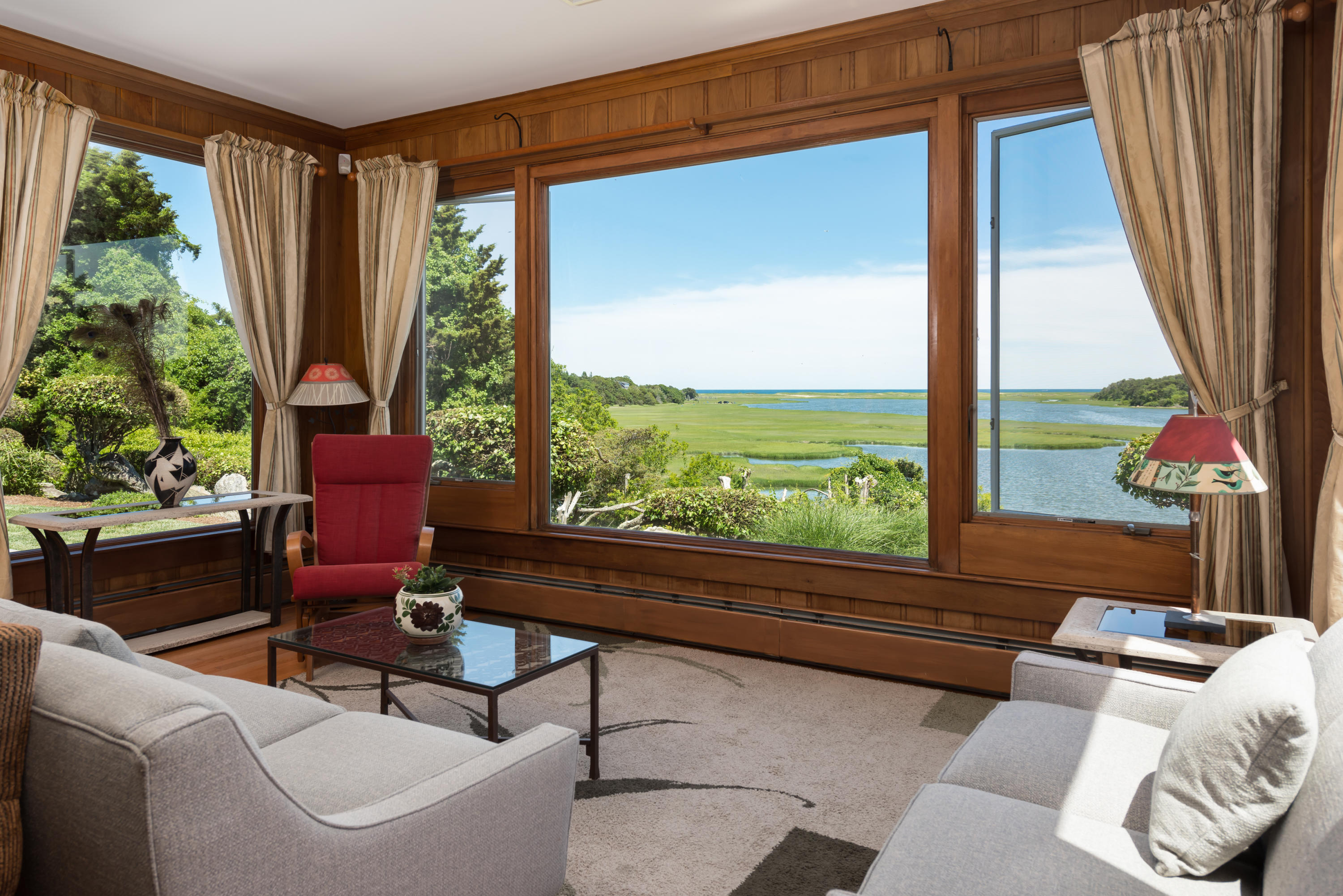 71 Briar Spring Road Orleans, MA 02653 - Photo 23 of 45 a living room with furniture and a floor to ceiling window