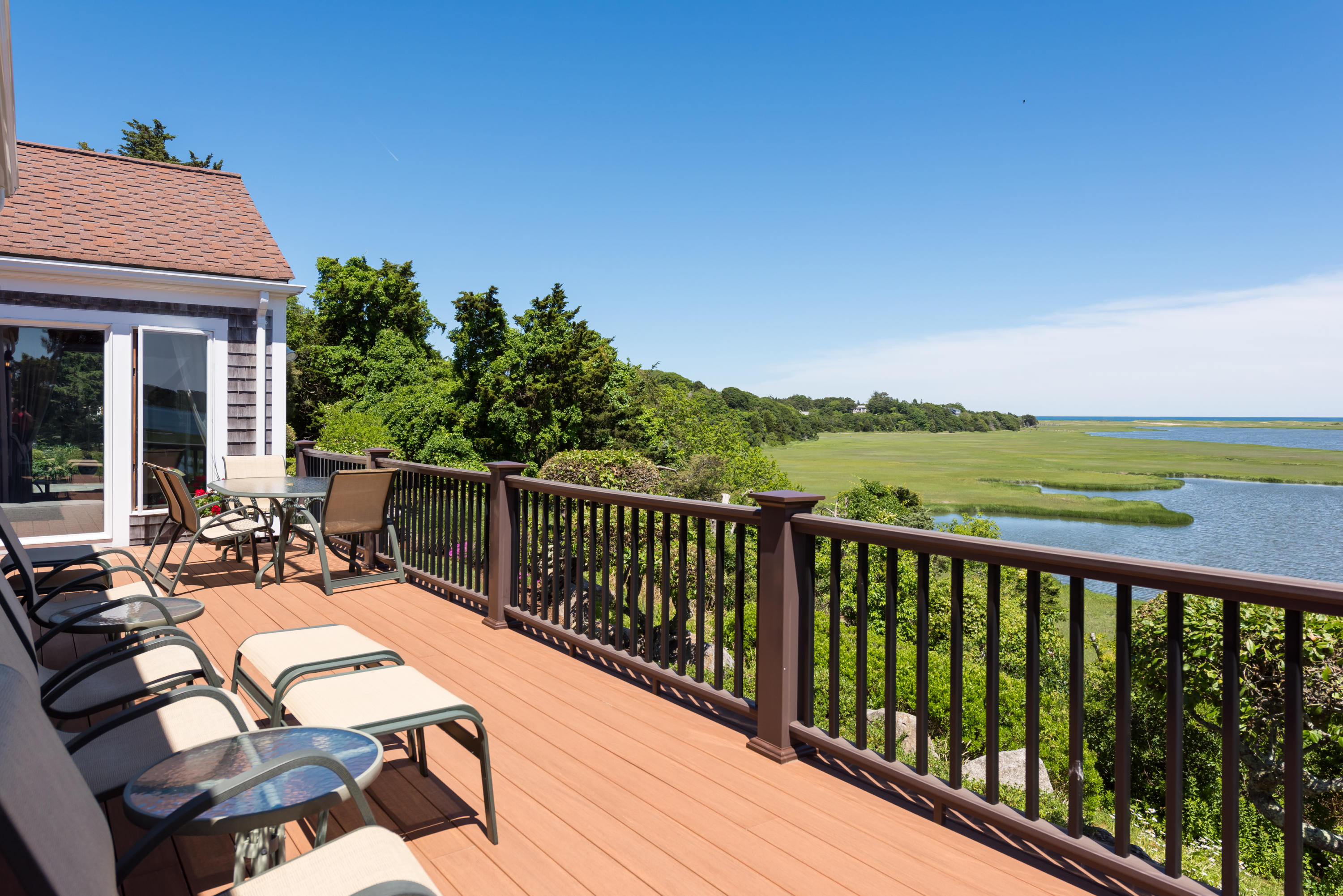 71 Briar Spring Road Orleans, MA 02653 - Photo 3 of 45 a view of a patio with chairs and wooden floor