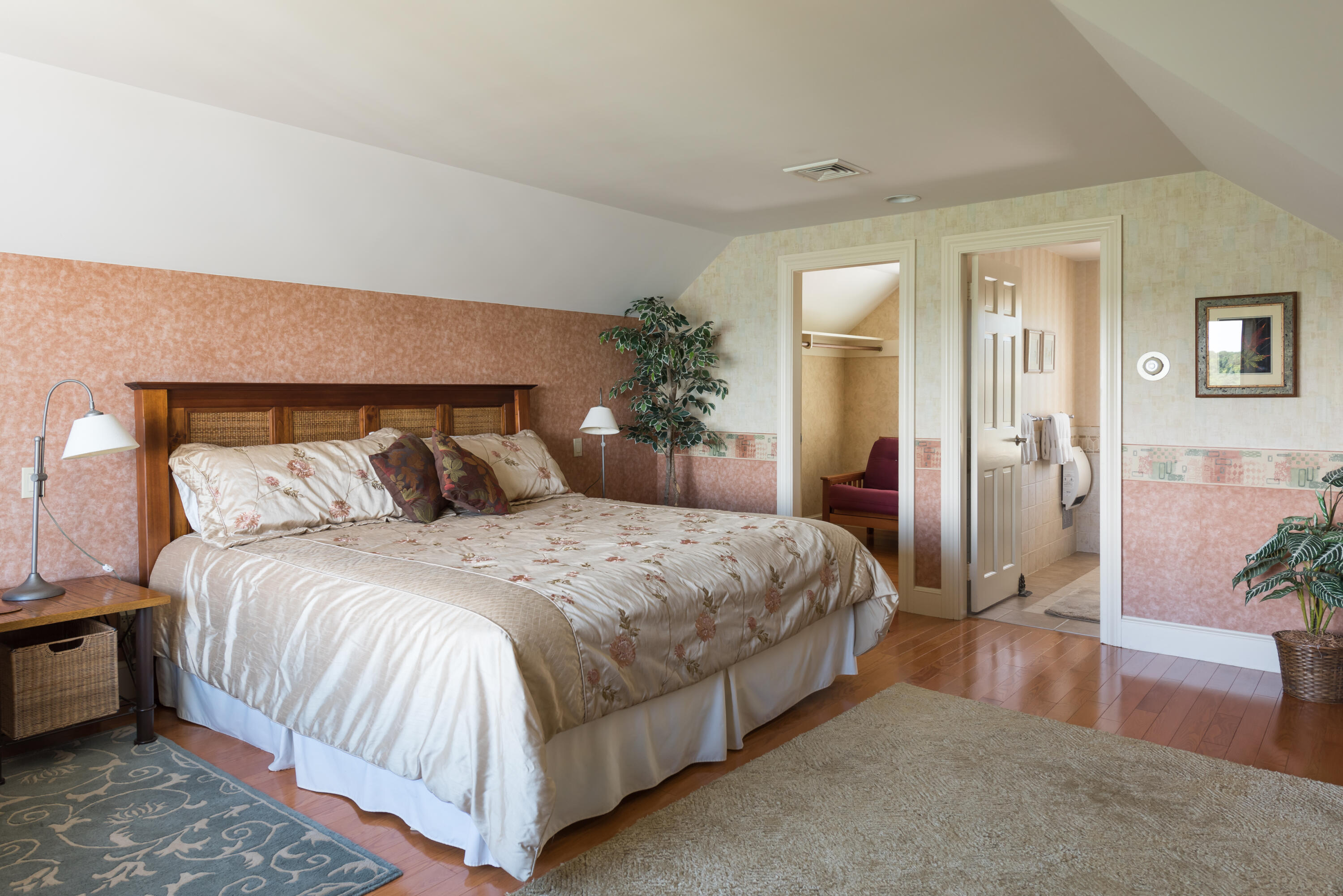 71 Briar Spring Road Orleans, MA 02653 - Photo 41 of 45 a spacious bedroom with a bed and a potted plant