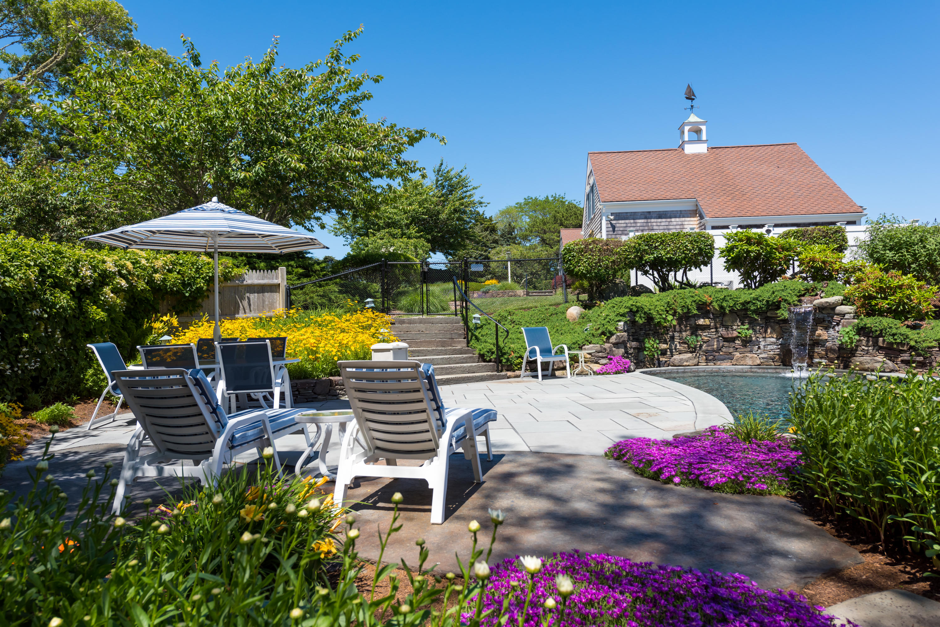 71 Briar Spring Road Orleans, MA 02653 - Photo 45 of 45 a view of a patio with table and chairs and potted plants