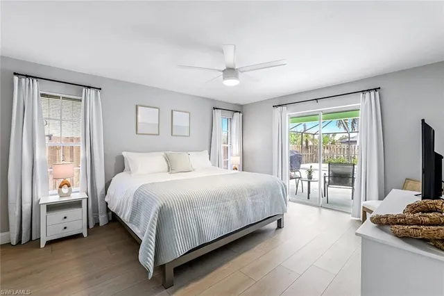 a bedroom with a bed and a flat tv screen on the dresser