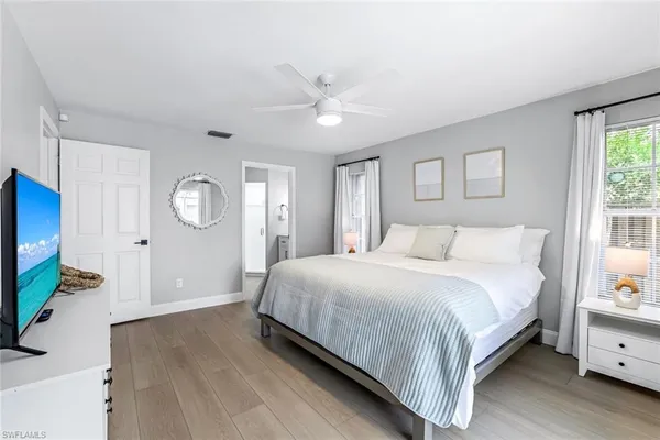 a spacious bedroom with a bed and a window