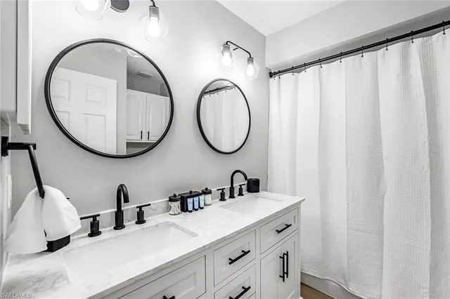 a bathroom with a double vanity sink and a mirror