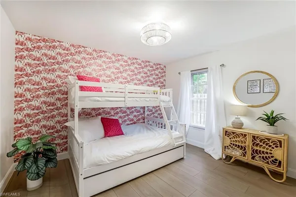a bedroom with a bed and a potted plant