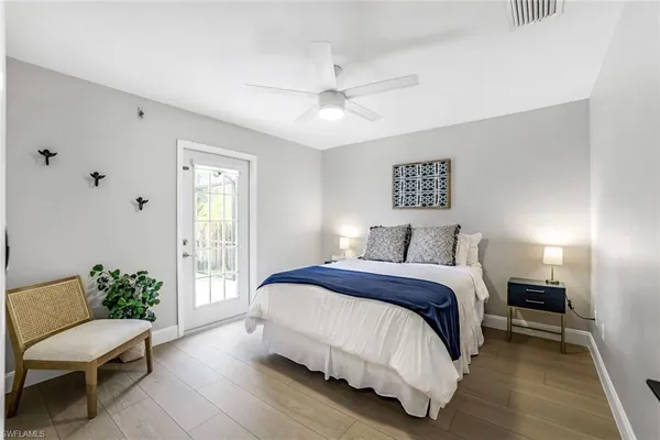 a spacious bedroom with a bed and a couch