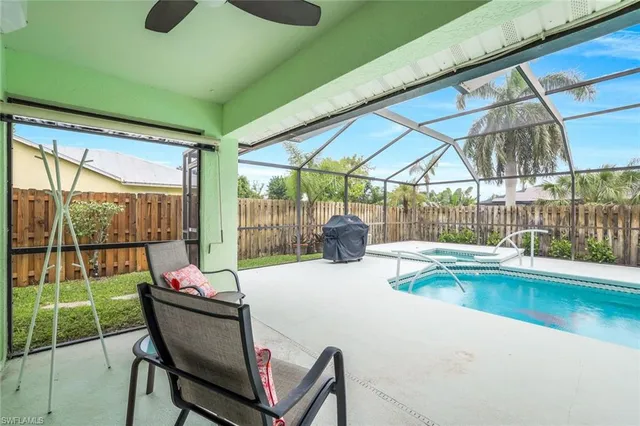 a view of a patio with a table chairs and a backyard