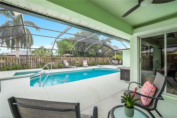 a view of swimming pool with outdoor seating