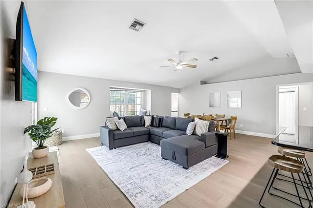 a living room with furniture potted plant and a window