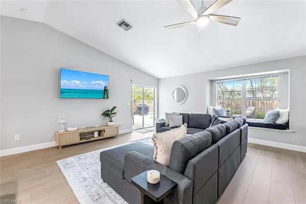 a living room with furniture and a large window