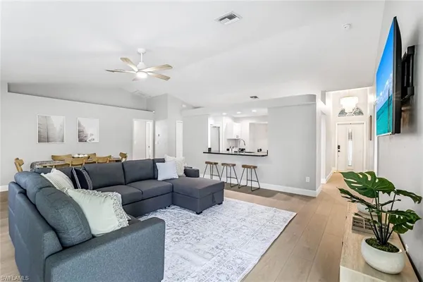 a living room with furniture ceiling fan and a rug