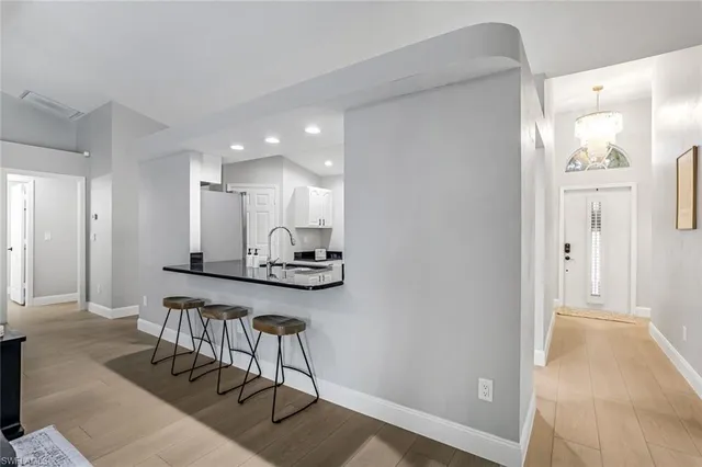 a view of kitchen with furniture and a refrigerator